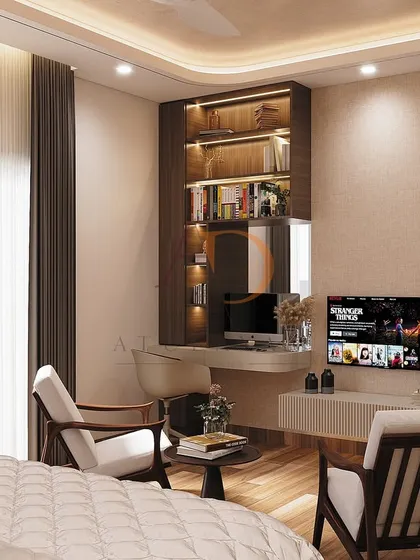 This bedroom includes a cozy conversation corner with mid-century lounge chairs and a compact study nook integrated with the floating TV unit.