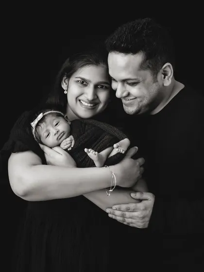 The same family portrait in black and white. This version emphasizes the emotion and connection, creating a timeless, artistic image.