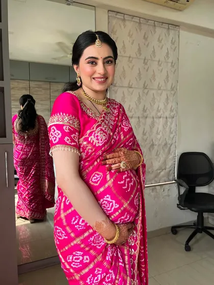 Divya looked absolutely stunning, cradling her baby bump. The soft makeup complements her traditional attire perfectly.