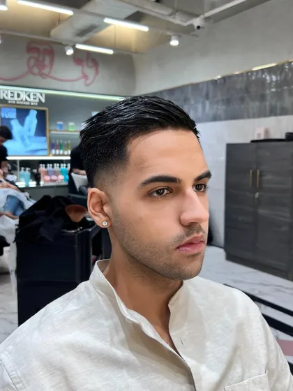 Another angle of this sharp fade. Precision is key when it comes to men's grooming, and I take pride in getting it right every time.