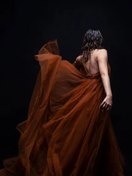A back view of the wet-look hairstyle, showing how the curls are defined and textured. This style is designed to look beautiful and intentional from all angles, even in motion.