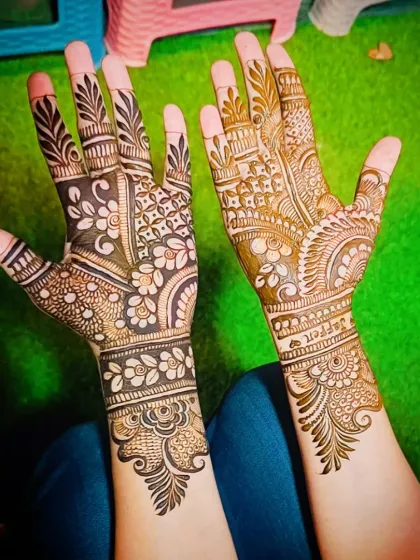The same design from a different angle, highlighting the bold floral work on the palm.