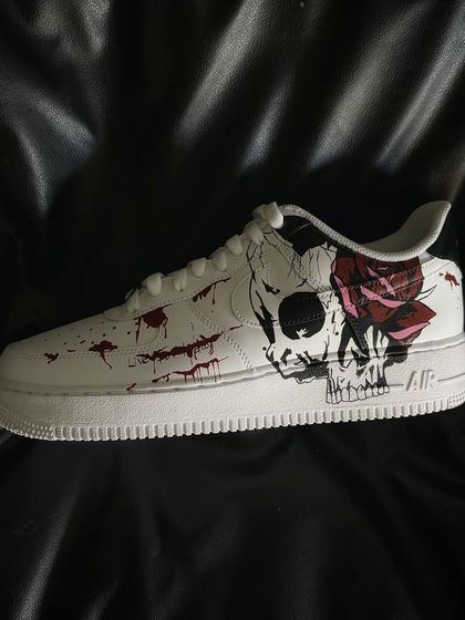 A spooky Halloween-themed custom Nike Air Force 1 with a skull and rose design.