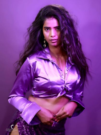 A powerful and direct portrait. Her intense gaze and the bold purple lighting create a captivating and modern image.