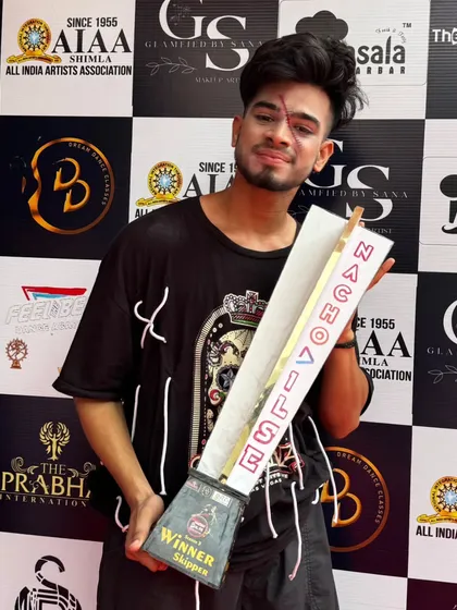 Holding the trophy with a scar on my face from the finale performance makeup. We literally put our blood and sweat into our art.