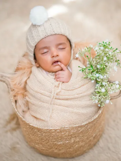 A classic and cozy newborn portrait that feels warm and timeless. Using a soft, hand-knitted hat and wrap, I nestled this little one into a rustic basket to create a picture of pure comfort and innocence.