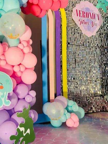 A close-up of the cute octopus and jellyfish cutouts that add to the charm of this Mermaid party decor.