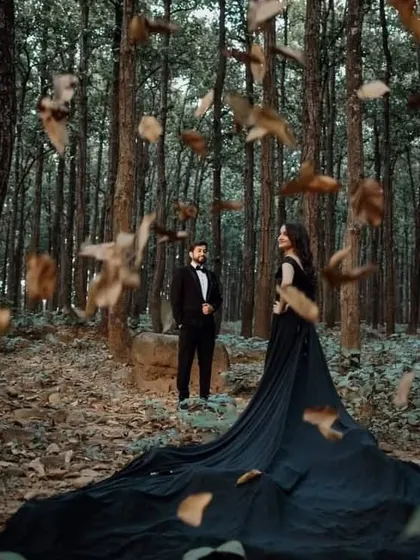 Create a moody and enchanting atmosphere with our off-the-shoulder black trail gown. The long, flowing train spreads out beautifully, making it ideal for romantic forest shoots where the dark fabric contrasts with the natural surroundings.
