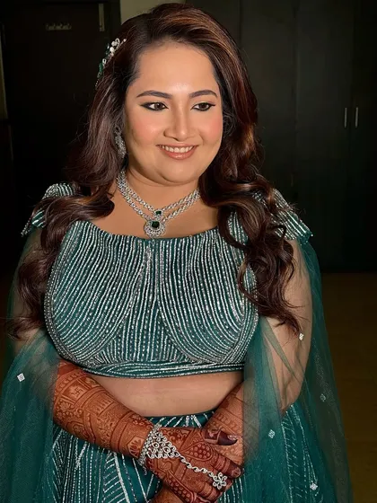A candid shot of the bride enjoying her sangeet. The makeup is designed to look great from all angles and to last through hours of dancing and fun.