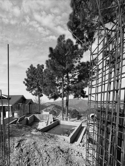 Building in the mountains is a patient endeavor. This image from a site in Himachal shows the beginning of a concrete house taking shape amidst the pine trees, a result of a year-long effort to create form and space on the terraced slopes.