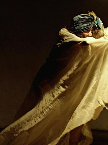 A photo capturing movement and fabric in one of my solo pieces. The costume becomes a partner in the dance, creating its own shapes and shadows.