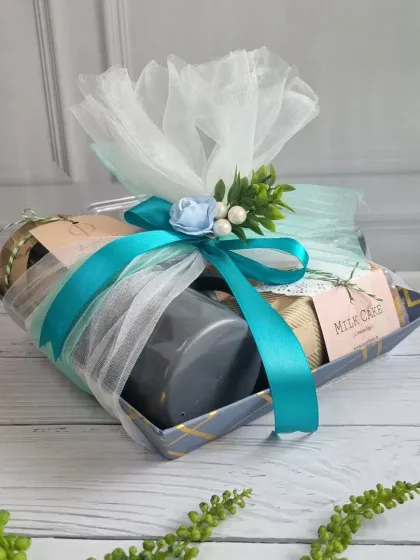 A stylish corporate hamper wrapped in white and turquoise, filled with our handmade treats. It's a memorable gesture for clients and employees.
