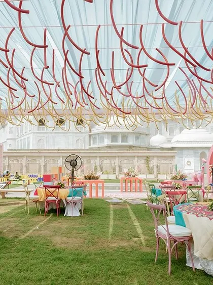 The ceiling decor for the carnival Mehendi, featuring hanging colorful pool noodles to create a playful and unexpected textural element.