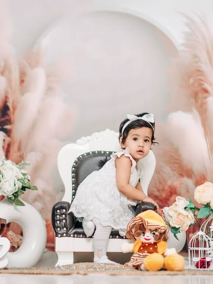 A classic and elegant first birthday portrait. The simple white dress and our popular pampas grass studio backdrop create a timeless and beautiful image.