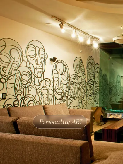 This personality-filled mural features a continuous line-art drawing of abstract faces, creating a unique and highly artistic statement wall in a modern living space.