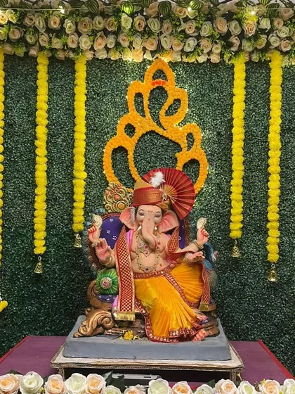 For a fresh and traditional feel, we designed this setup using a lush artificial grass wall. The look is completed with classic yellow marigold garlands and a floral Ganesha emblem, bringing an auspicious and natural vibe to your home.