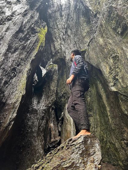 A trekker exploring the inside of the massive Yaana rock formations.