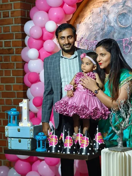 A family portrait from a 'Love You to the Moon and Back' themed first birthday. Seeing our clients happy in the beautiful setting we created is our ultimate goal.