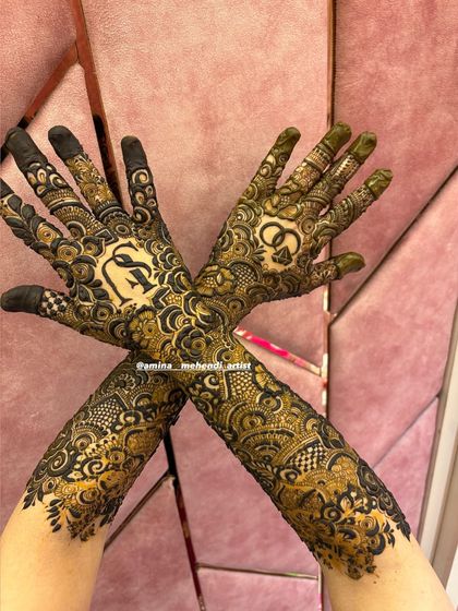 A crossed-hands pose showing the initials 'S' and 'A' and a ring motif.