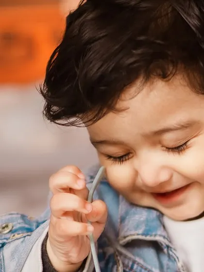 A close-up shot capturing a sweet, shy smile. Even with a grand theme, I always focus on capturing the small, intimate expressions of your child.