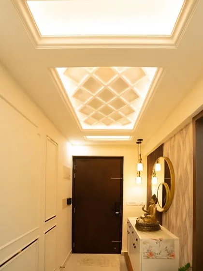 This foyer at Pashmina Waterfront uses a beautifully backlit coffered ceiling to add warmth from above. A floating console with a Buddha idol brings a sense of peace.