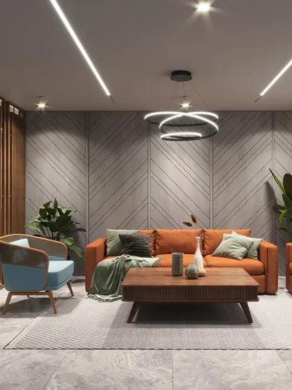 A modern living area designed for comfort and style. The room features a bold orange sofa, a textured concrete accent wall with diagonal grooves, and contemporary lighting fixtures, creating a vibrant yet sophisticated space for relaxation and socializing.