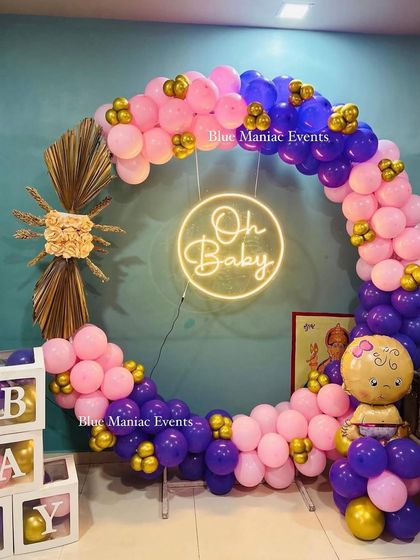 Another angle of the pink and purple 'Oh Baby' shower decoration, showing the baby girl foil balloon integrated into the balloon arch.