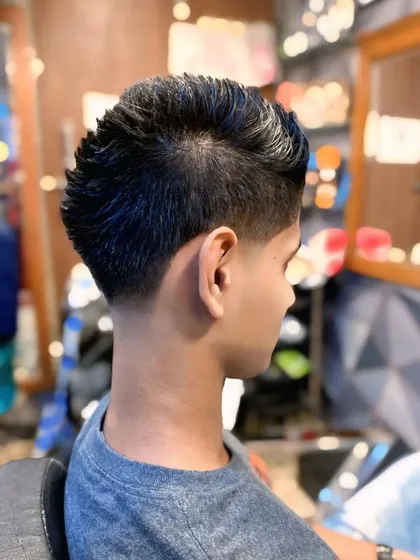 This haircut features a taper fade on the sides with a textured, spiky style on top. It's a youthful and energetic look.