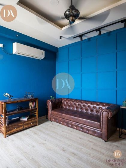A full view of the lounge area with the blue paneled wall. This design choice creates a multifunctional space that is both a study and a play area, reflecting our philosophy of creating adaptable, connected homes.