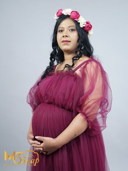 A confident and direct portrait of the mother-to-be. The combination of the beautiful gown and floral crown creates a stunning and memorable image.