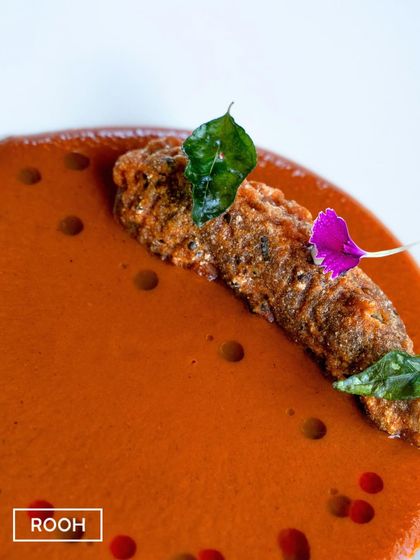 A close-up on the crispy Prawn 65. This dish is a journey of textures, from the crunchy coating of the prawn to the smooth, velvety curry.