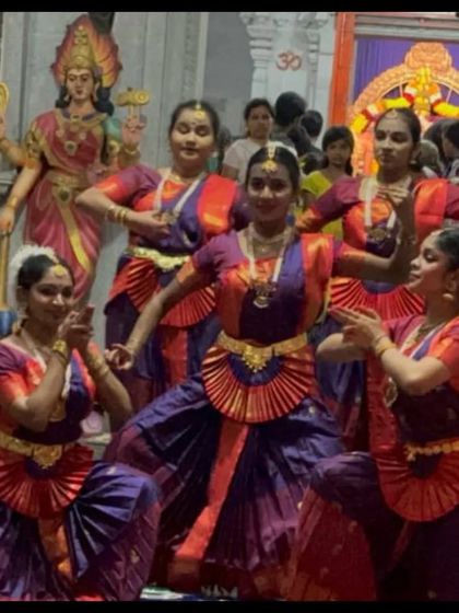 My students performing at the Bhavani Shankara temple during Navaratri, with the deity in the background. The temple architecture adds to the divine ambiance of the performance.