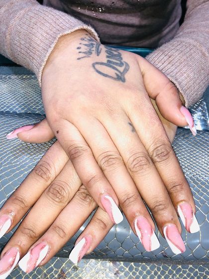 A unique marble design using pink and white on long, square nails.