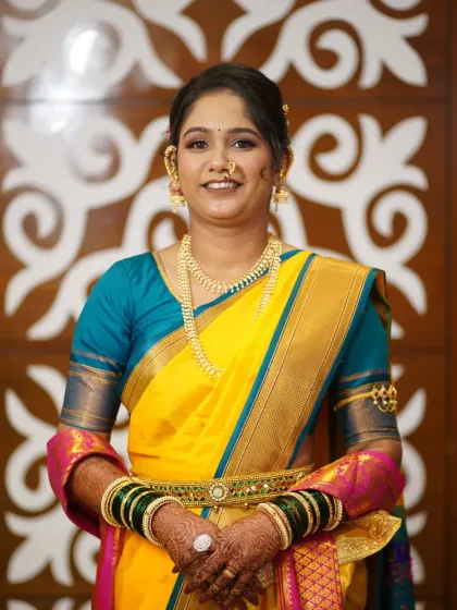 A happy, smiling bride ready for her pre-wedding rituals. The makeup is light and dewy, perfect for a daytime event.