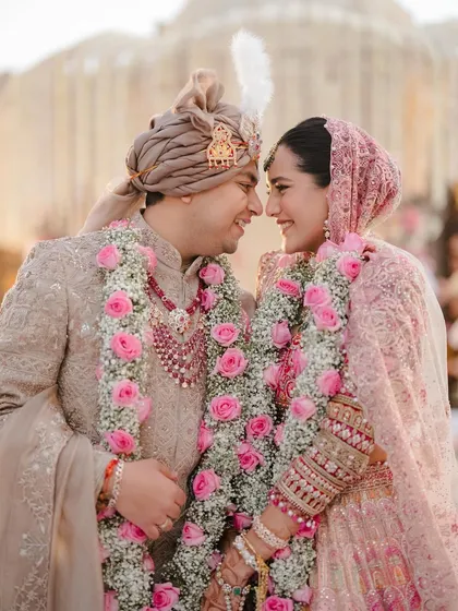 A close-up of two souls connecting. The soft pink rose garlands and the couple's coordinated pastel outfits, styled by me, create a frame of pure romance and intimacy.