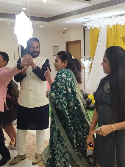 Interacting with the birthday boy and his wife during the celebration. These personal touches help make the event feel intimate and special.