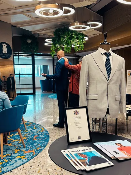 The scene at our KPMG trunk show, where an executive is being fitted for a suit. Our process is interactive and educational, taking place in a comfortable lounge setting that encourages conversation about style, fit, and function.