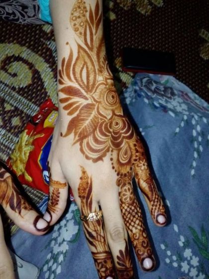 A detailed design with a mix of floral and leafy elements, showing the rich stain.