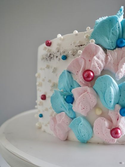 This is a close-up of the delicate, hand-piped floral work on one of my baby shower cakes. I use soft buttercream to create petal-like textures, accented with sugar pearls for a touch of elegance.