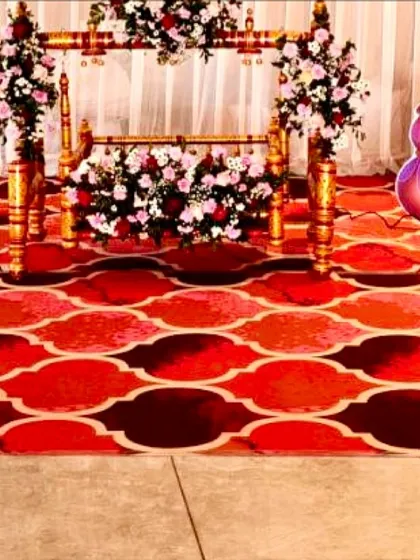 The beautifully decorated wooden cradle, or thottil, adorned with garlands of fresh flowers for a traditional naming ceremony.