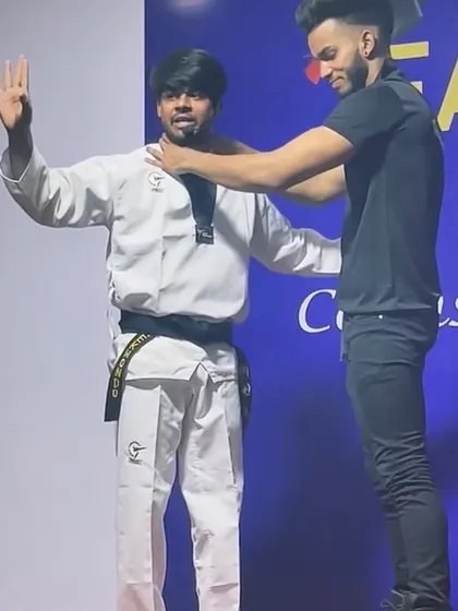 Taekwondo is not just for the ring; it is for life. Here, I am demonstrating a simple but effective self-defense technique on stage. My goal is to empower every student with the confidence to protect themselves.