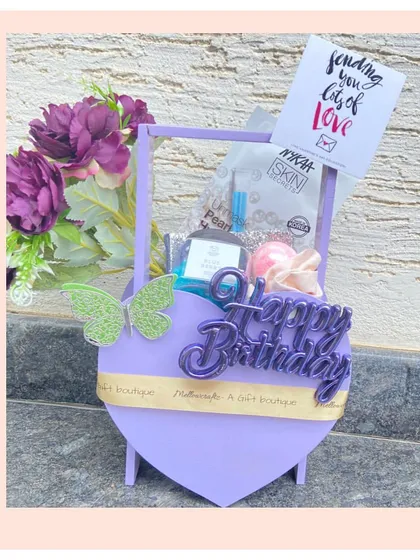 A mini heart-shaped basket hamper in a lovely lavender shade. It's a sweet and simple way to send birthday wishes, filled with skincare goodies and decorated with a butterfly accent.
