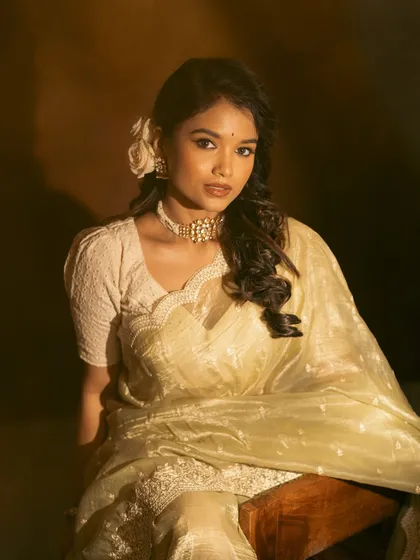 A direct, captivating gaze from the actress. This shot highlights the beauty of the simple yet elegant jewellery.