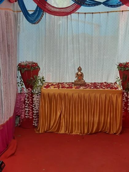 A small table setup for a Buddhist ceremony or as part of a larger event decor.