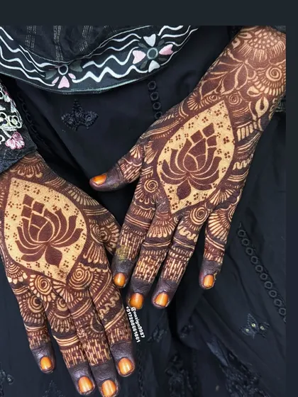 I love working with different floral motifs. This design features a prominent lotus at the center of the palm, a symbol of purity and beauty, surrounded by detailed filler patterns for a classic Indian bridal style.