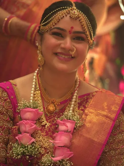 A happy close-up of my bride Sanjana during her muhurat, her smile lighting up the frame.