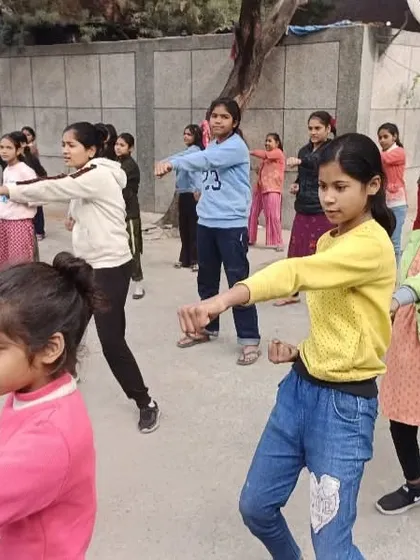 A group of girls learning basic self-defense stances. Building muscle memory for these stances is a key part of the training.
