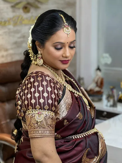 A close-up of her soft makeup and the intricate details of the temple jewellery necklace and jhumkas.