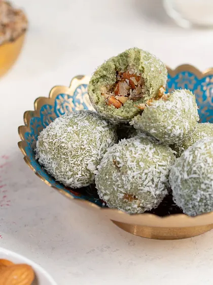 Paan Laddoos, a unique and flavorful festive treat. The vibrant green color and coconut coating make for a beautiful and unusual food photograph.