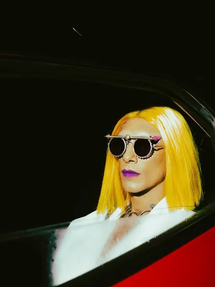 We pushed the boundaries for this high-fashion editorial concept. The bold styling with yellow hair and unique glasses, combined with dramatic night lighting, creates a rebellious and unforgettable image.